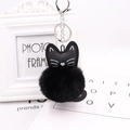 Detailed view of plush black cat keychain with faux fur ball and silver metal clasp - Black