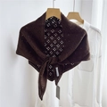 Detail of dark coffee knitted hollow shawl with intricate crochet pattern on a hanger - Hollow Four-leaf Brown
