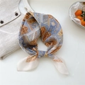 Floral retro silk scarf with geometric patterns in blue and brown, tied in a stylish knot - 10 Blue Yellow Four Leaf Clover Grid