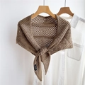 Detail of brown crochet knit triangular shawl with mesh pattern and woven brand label - 82x82x142cm / Camel