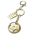 Macro detail of golden barbell weight plate keychain with engraved motivational text plates - Gold Barbell Plate & Rectangular Tag