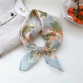 Elegant floral print silk scarf with green and blue patterns tied for styling - 23 Colorful Leaves Yellow