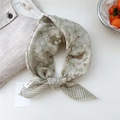 Elegant green floral square cotton linen scarf with geometric print border in a flat lay view - Green Leaf Print