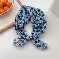 Blue and white floral cotton-linen neck scarf tied in a bow on a white desk - 11 Navy Leaf Floral