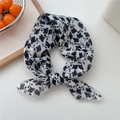 Floral print cotton linen scarf featuring black and white patterns tied in a bow - 12 Rice White Leaf Floral