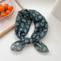 Dark green cotton-linen neckerchief featuring white paisley patterns tied in a knot - 10 Green Paisley Pattern