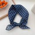 Navy blue cotton headscarf with white floral patterns tied in a decorative bow knot - 10 Floral Dots Navy Blue