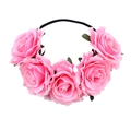 Detail of pink artificial rose headband featuring five realistic flowers and green leaves - White Edge Pink