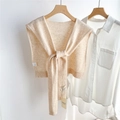 Close-up of beige 100% wool knitted shawl detail with texture and brand label - Off-white