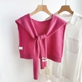Detail of fuchsia 100% wool knitted shawl with ribbed edges and tie-front over white shirt - Rose Purple
