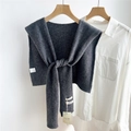 Detail of dark grey wool knit shawl accessory showing soft texture and tie-up design - Gray
