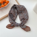 Brown and light blue floral silk scarf tied in a bow on a white decorative background - 25 Fountain Pattern Brown