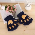 Detailed macro of dark blue plush cat paw gloves with soft faux fur texture on wood - Navy Blue