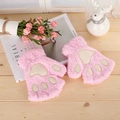 Detail of pink plush cat paw fingerless gloves with soft embroidery on wooden surface - Pink