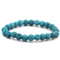 Blue volcanic stone beaded bracelet featuring natural 8mm lava rock beads on a white surface - Blue