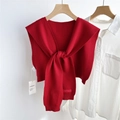Detail of red knitted shawl featuring ribbed edges, knotted style and brand tag - Red (04D)