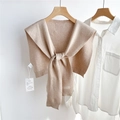 Vue détaillée d'un châle en maille abricot noué sur une chemise blanche avec étiquettes - Style avec Étiquette Brodée (23D) / 43x98cm / Blanc Cassé