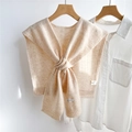 Detail of beige wool knitted shawl showing 100% wool label and ribbed edge texture - Marled Beige