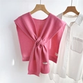 Detail of pink knitted wool shawl showing the 100% wool label and soft ribbed texture - Deep Pink