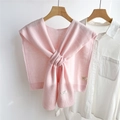 Detail shot of pink wool shawl label showing 100% wool material and knitted texture - Light Pink