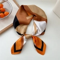 Silk scarf with geometric orange and brown print tied in an elegant knot style - Khaki Orange Geometric Strip