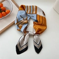 Silk scarf with equestrian horse print in orange and blue, styled with a decorative knot - Black Horse Check Border