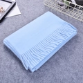 Thick sky blue cashmere-like scarf with fringe detailing folded on grey felt surface - Light Blue