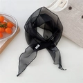 Detalle de un fino pañuelo de seda negro translúcido con nudo natural para mujer - Negro
