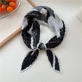 Pleated black and white silk scarf with artistic rose pattern shown in an elegant knot - Black Multi-Petal Floral