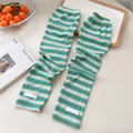 Close-up of knit striped sun protection sleeves with ribbed cuffs and brand label - One Size / Green Orange Stripes