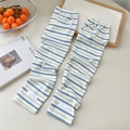 Close-up of striped cooling arm sleeves with thin knit texture and pink label detail - One Size / Mixed Stripes