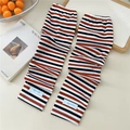 Detail of striped cooling arm sleeves featuring orange and black knit texture and elastic band - One Size / Three-tone Orange Red