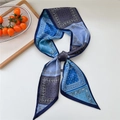 Blue and grey paisley pattern skinny silk scarf tied in a bow on a white background - Grid Blue Paisley