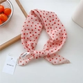 Pink scarf with red polka dots styled in a bow with minimalist tag and wood tray decor - Pebble Pattern Pink