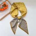 Ginger yellow silk scarf with paisley and geometric patterns in a knotted flat lay display - Flower Paisley Yellow