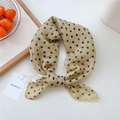 Polka dot silk scarf in beige with black spots tied neatly for a stylish summer look - Pebble Pattern Yellow