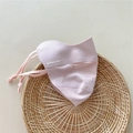 Close-up of a pink breathable sun mask with adjustable ear straps on a round rattan mat - One Size / Pink