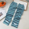 Close-up of striped cooling arm sleeves with high-elastic knit fabric and letter logo label - One Size(10x50cm) / Blue Black and Red Stripes