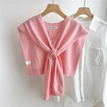 Detail of soft pink 100% wool knitted shawl with crossed knot design on white shirt - Pink