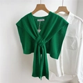 Close-up of emerald green knitted shoulder wrap with elegant front knot detail - Dark Green