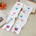 Close-up of white sun protection sleeves with pink 'HOT' print and blue hearts - HOT White (11 Pink Label)