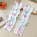 Detail of white cooling arm sleeves with cute cartoon patterns and pink brand label - Pink Unicorn (13 Pink Label)