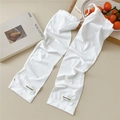 Detail of white knitted sun protection arm sleeves with textured ribbing and woven logo - One Size / White