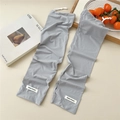 Detail of light gray cooling sun sleeves with adjustable drawstring and knit texture - One Size / Light Gray