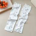 Detail of white cooling arm sleeves with a cute cartoon little dog print and text - 12 Minimalist Dog
