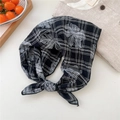 Detailed close-up of a knotted cotton linen scarf with black and white floral plaid patterns - Black Plaid Floral