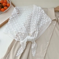Detail of white lace crochet belt with floral pattern tied over a beige shirt - Four Leaf Grid / White