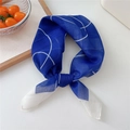 Navy blue printed cotton linen headscarf tied in a knot on a white minimalist desk - Deep Blue Thin Circles (52B)