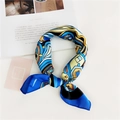 Detail of blue abstract silk scarf tied in a loop on a white table with magazine props - Geometric Blue Mix
