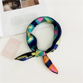 Detail shot of a colorful geometric silk scarf tied as a stylish neck accessory - Colorful Arrow